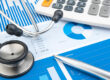 Healthcare professionals reviewing budget and spending data to improve financial visibility and spend-to-budget control across healthcare facilities.
