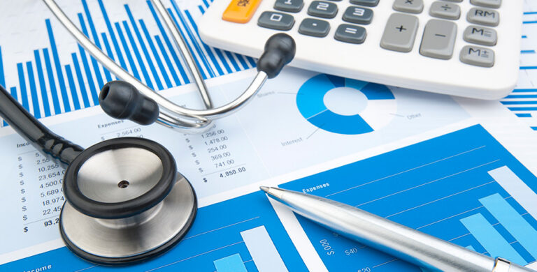 Healthcare professionals reviewing budget and spending data to improve financial visibility and spend-to-budget control across healthcare facilities.