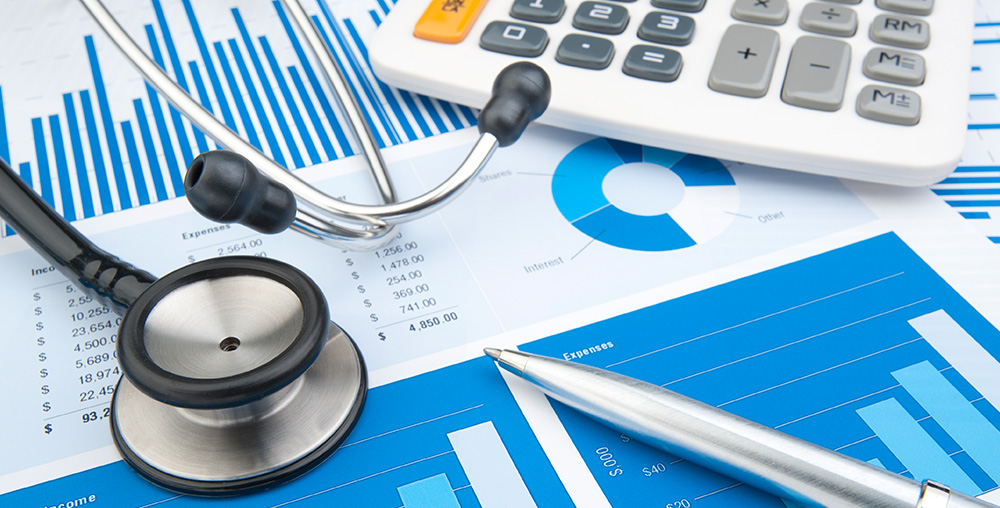 Healthcare professionals reviewing budget and spending data to improve financial visibility and spend-to-budget control across healthcare facilities.